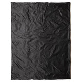 snugpak black jungle blanket laid flat